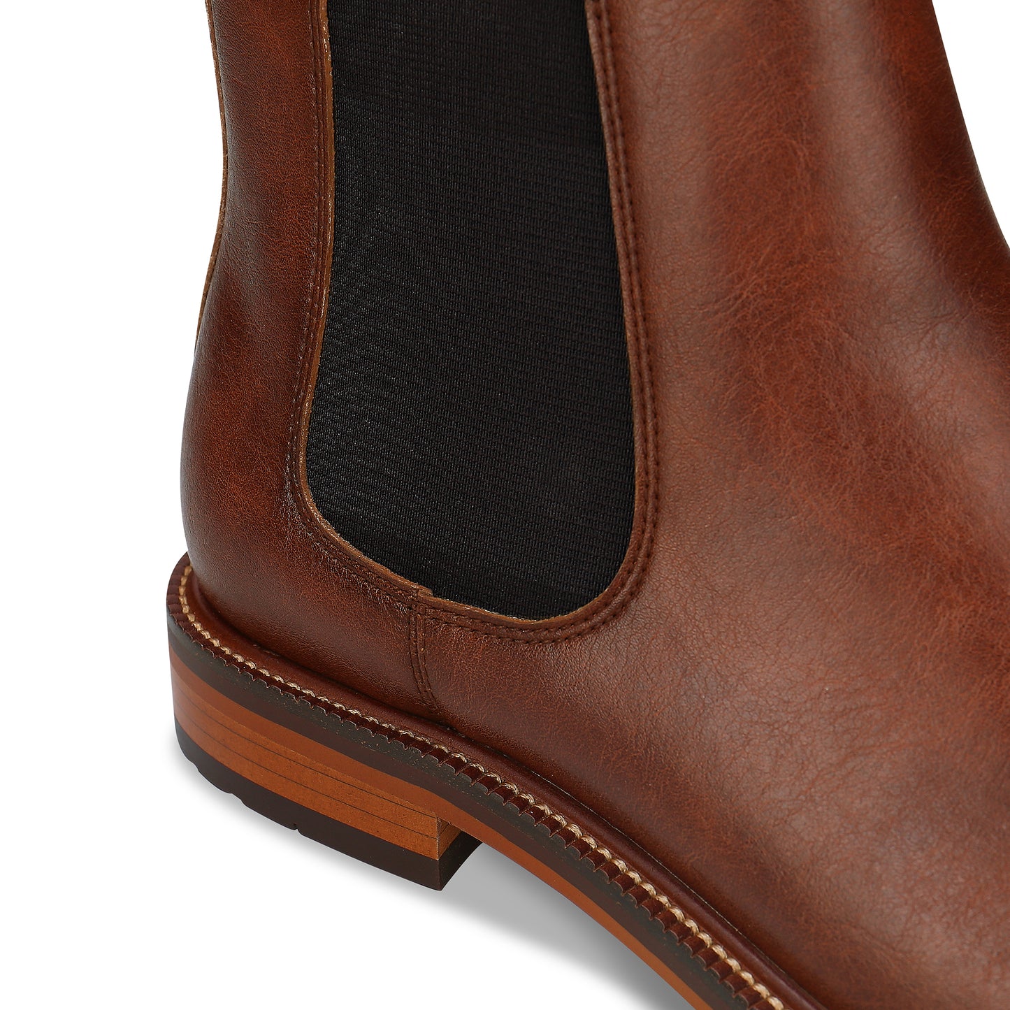 Close-up of a brown leather boot with a white background