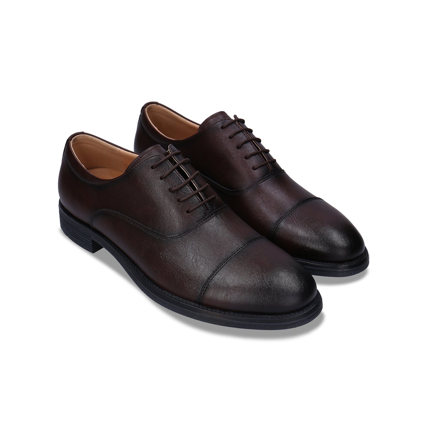 Pair of brown leather dress shoes on a white background