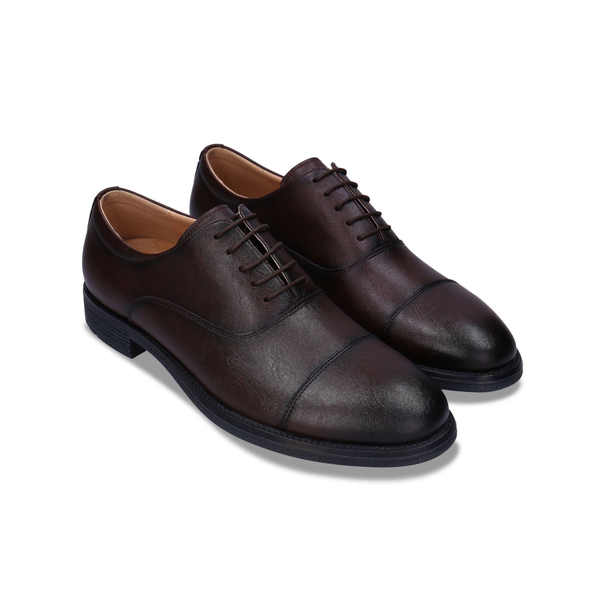 Pair of brown leather dress shoes on a white background