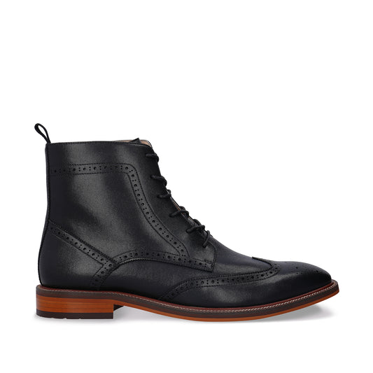 Black leather brogue boot with brown sole on a white background