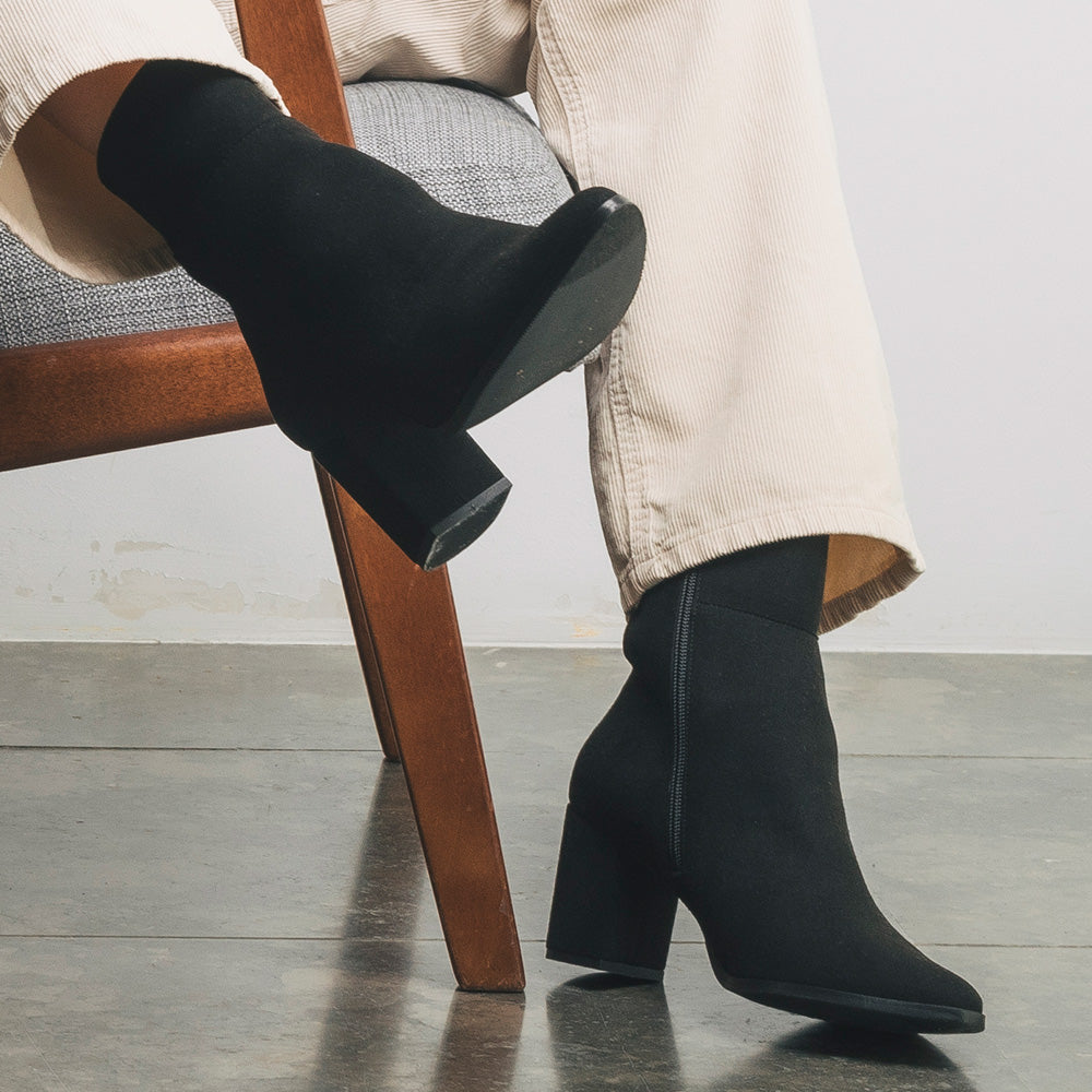 Women wearing black ankle boots with white pants lifestyle view | NAE Vegan Shoes