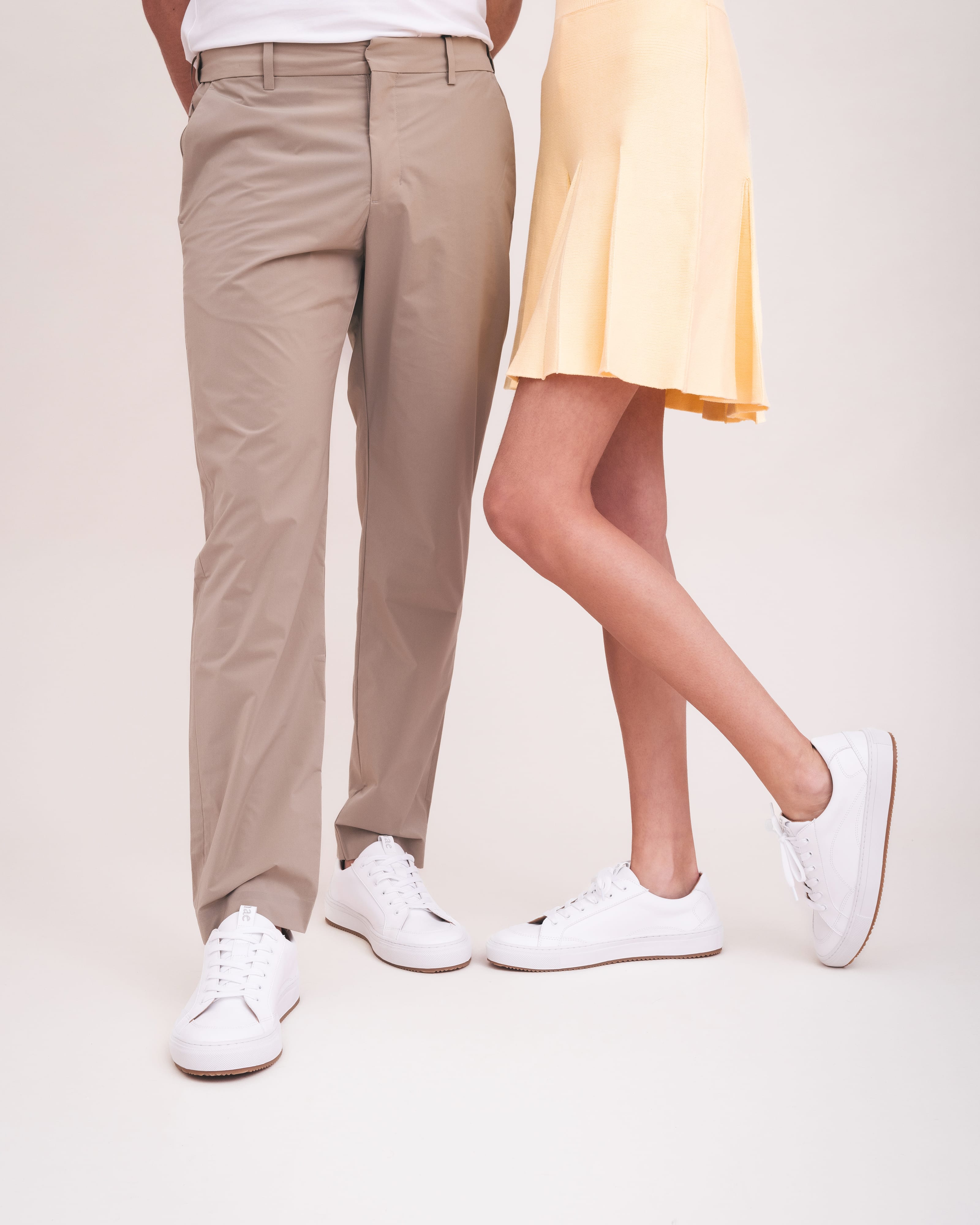 lifestyle picture unisex white vegan trainers with skirt and trousers