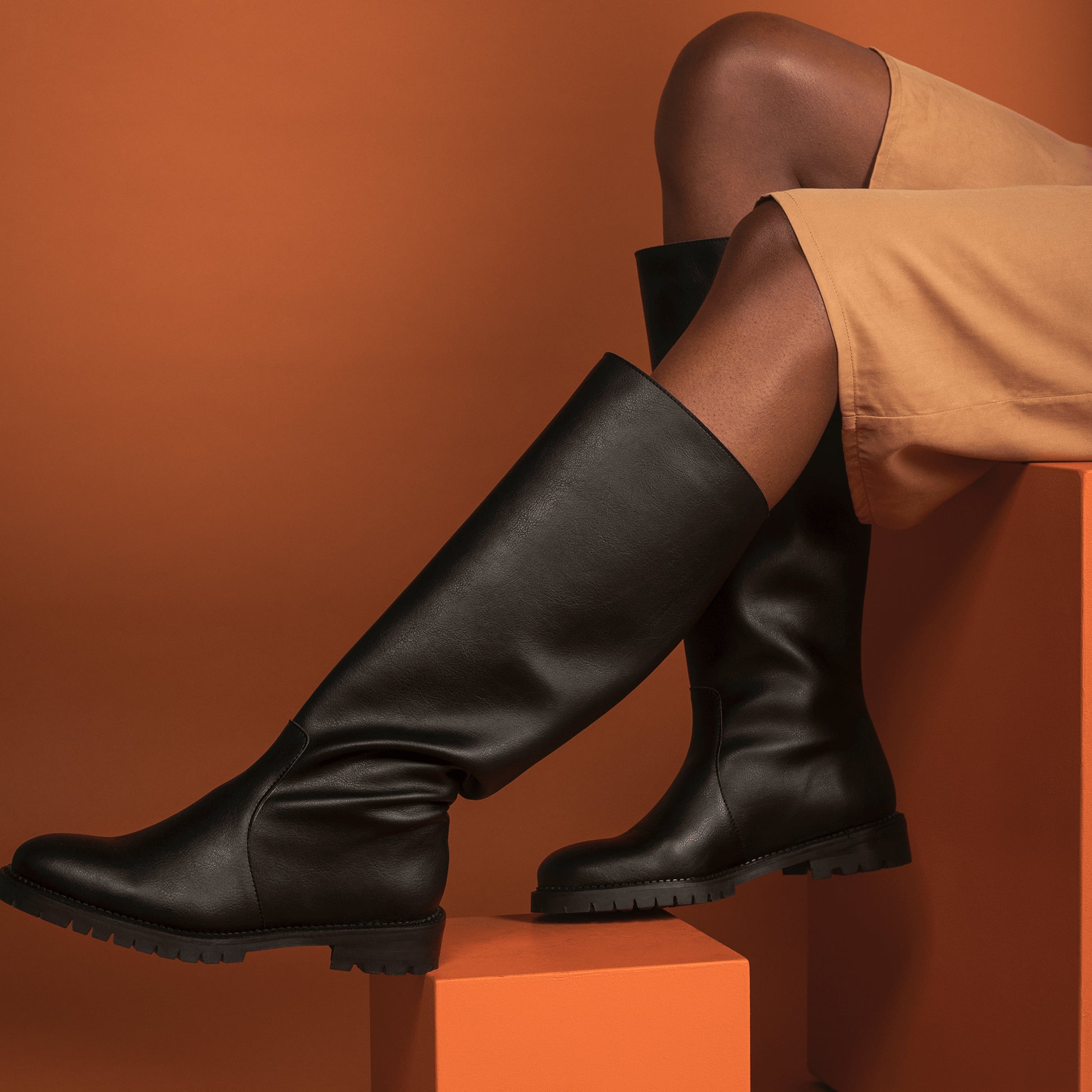 Women black vegan boots knee shaft wearing brown dress | NAE Vegan Shoes